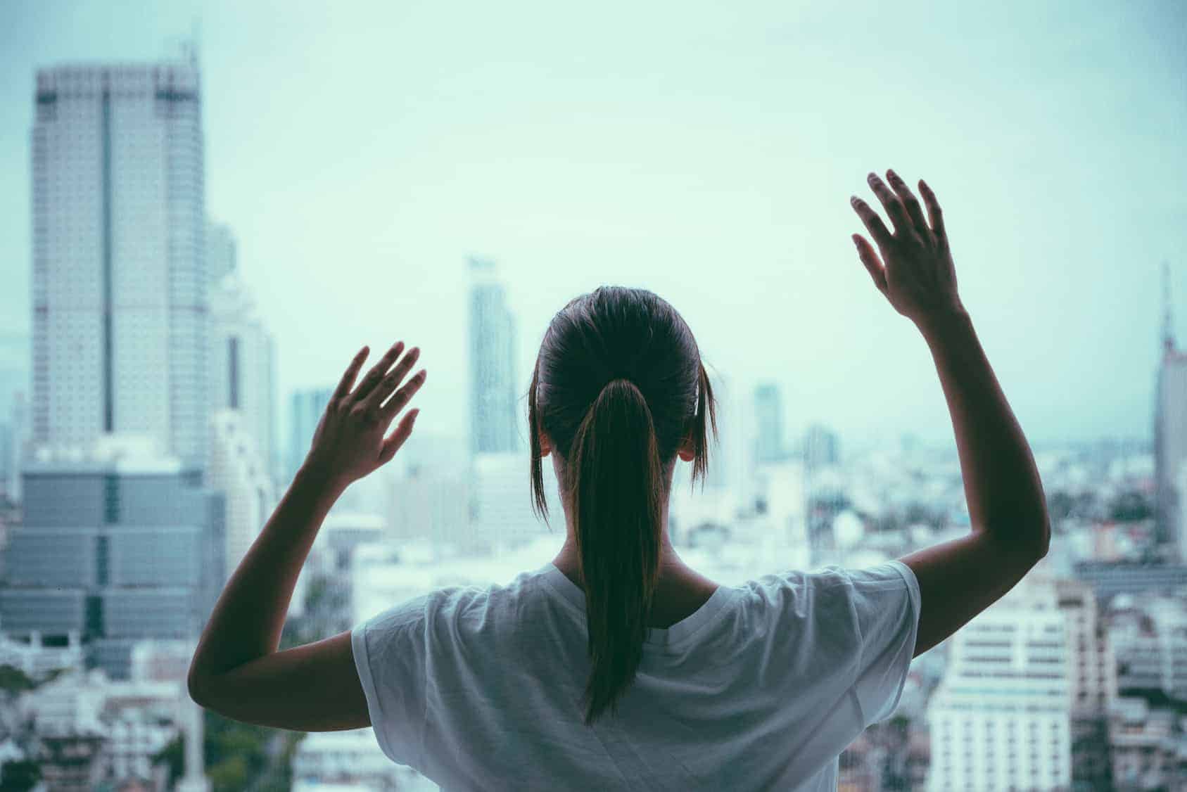 woman hands up on window