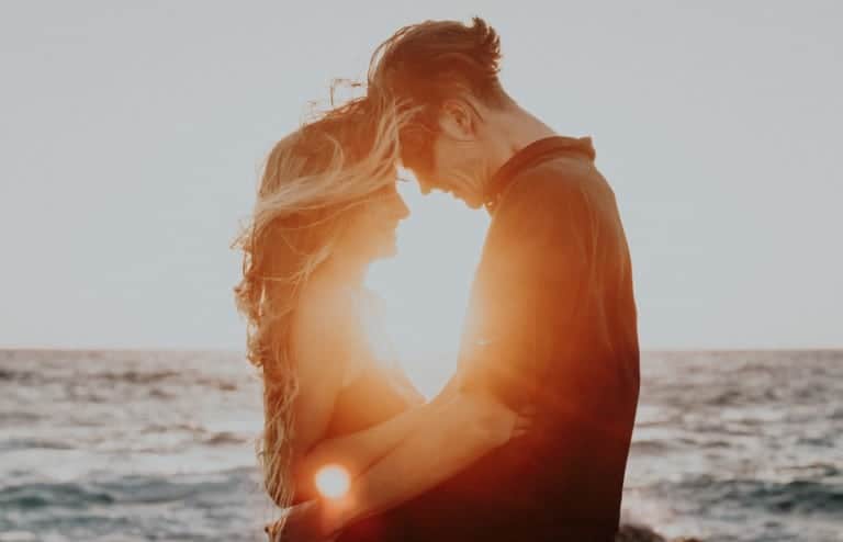 couple hugging at beach